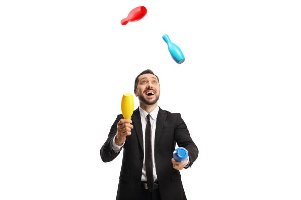 happy businessman juggling with clubs - jongleren stockfoto's en -beelden