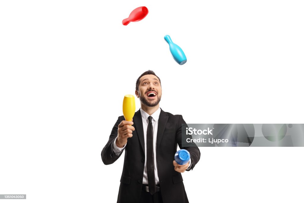 Happy businessman juggling with clubs Happy businessman juggling with clubs isolated on white background Juggling Stock Photo
