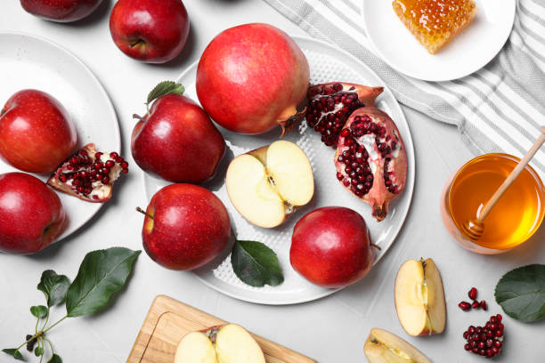 istock Honey, apples and pomegranates on light table, flat lay. Rosh Hashanah holiday 1351043086
