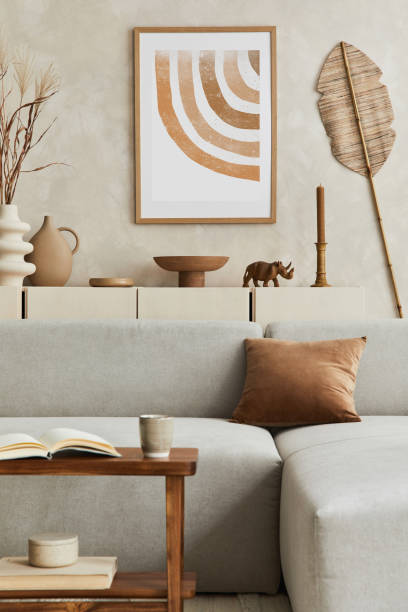 istock Elegant living room interior design with mock up poster frame, grey corner sofa, coffee table and personal accessories. Pastel neutral colours. Template. 1351043146