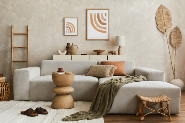 istock Elegant living room interior design with mock up poster frame, grey corner sofa, coffee table and personal accessories. Pastel neutral colours. Template. 1351043150