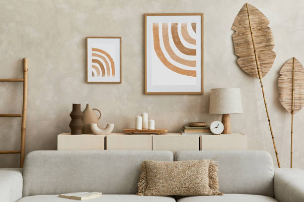 istock Creative composition of stylish living room interior with mock up poster frame, sofa, commode, clay vases and stylish personal accessories. Pastel neutral colours. Template. 1351043151