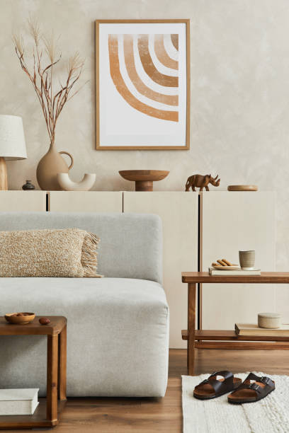 istock Elegant living room interior design with mock up poster frame, grey corner sofa, coffee table and personal accessories. Pastel neutral colours. Template. 1351043171