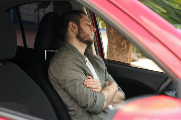istock Tired man sleeping in his modern car 1351043175