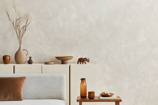 istock Stylish living room composition with copy space, grey sofa, clay vases and personal accessories. Pastel neutral colours. Template. 1351043179