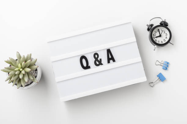 istock Q and A concept on lightbox with clock on white desk 1351043504