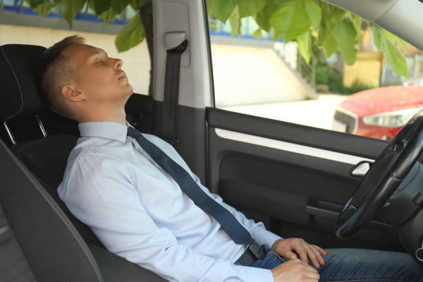 istock Tired young man sleeping in his modern car 1351044334