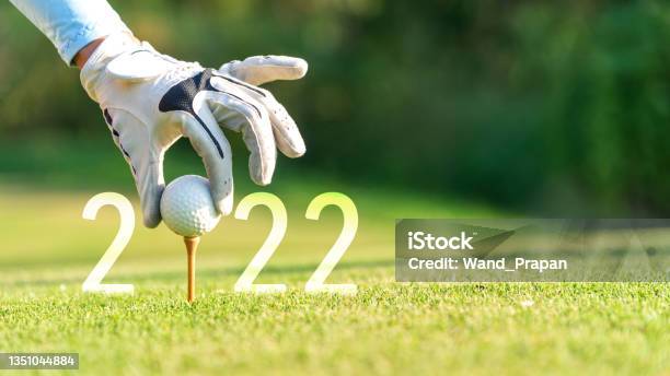 Close Up Hand Golfer Woman Putting Golf Ball For Happy New Year 2022 On The Green Golf For New Healthy Stock Photo - Download Image Now