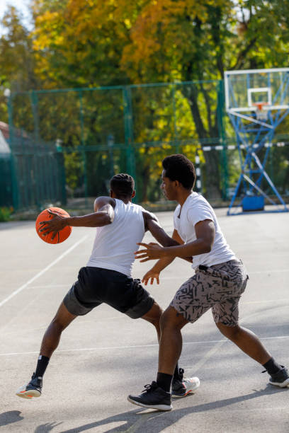 istock Two Black Friends Playing One On One Basketball 1351045170