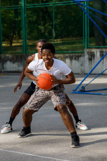 istock Two Black Friends Playing One On One Basketball 1351045203