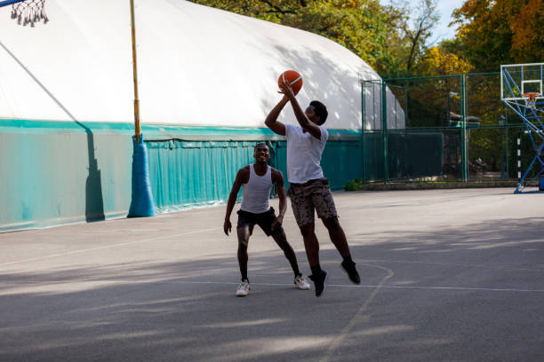 istock Two Black Friends Playing One On One Basketball 1351045461