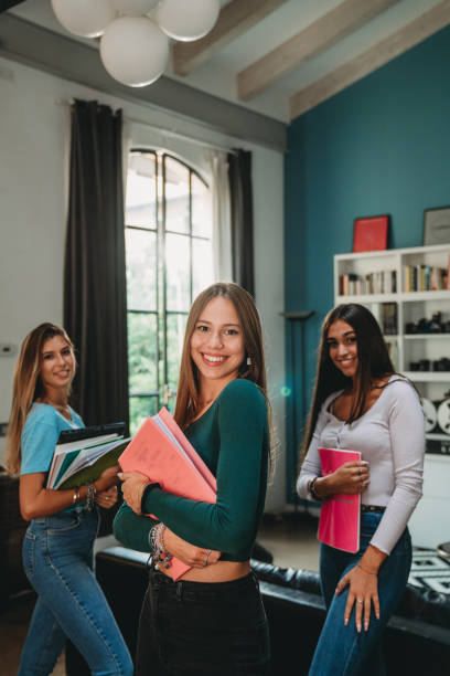 istock Portrait of three student friends looking at camera together 1351046896