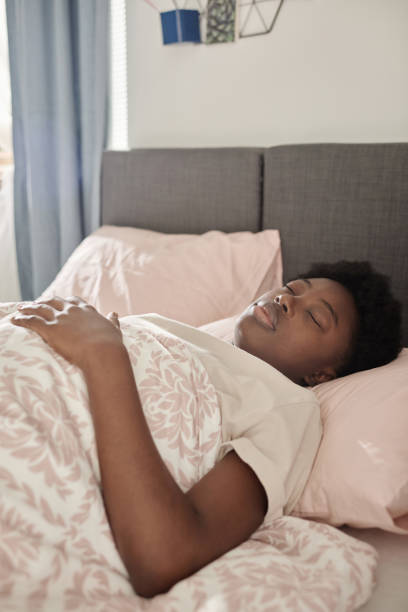 istock Woman sleeping in bed in her bedroom 1351047490