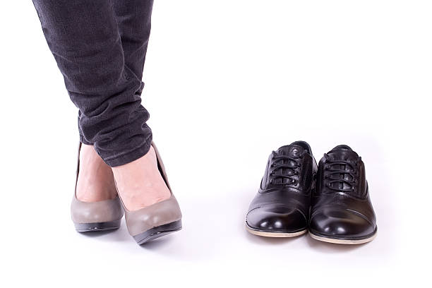 istock Women's feet and men's shoes 135104812