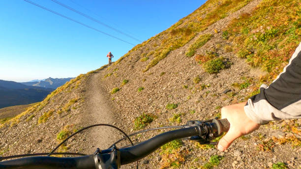 istock Mountain bikers follow trail through the Swiss Alps 1351048521