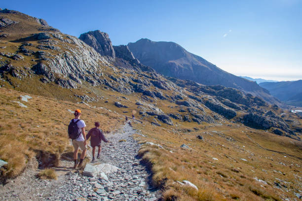 istock Friends follow hiking trail along mountain ridge 1351048552