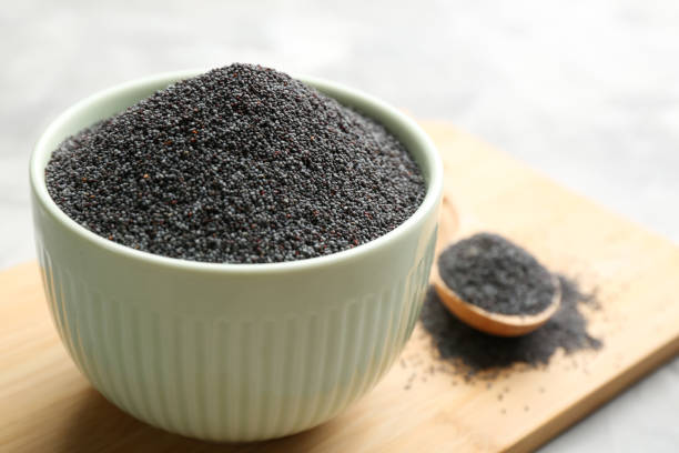 istock Poppy seeds in white ceramic bowl on table 1351048823