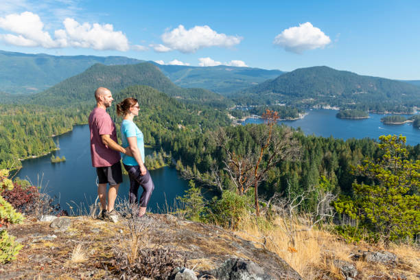 istock Hiking couple relax at viewpoint, on mountain ridge 1351048983