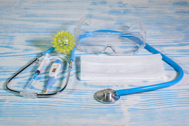 istock Medical protective masks and stethoscope on a blue wooden surface. Cavid-19 coronavirus infections 1351049404