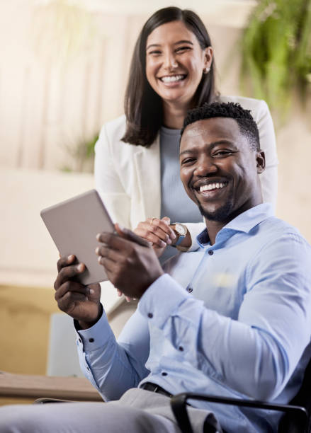 istock Shot of two coworkers using a digital tablet together 1351050961