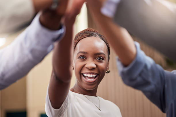 Shot of a young businesswoman high fiving her work colleagues I'm excited to work with you all passion stock pictures, royalty-free photos & images