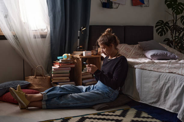 istock Woman using phone at home 1351052891