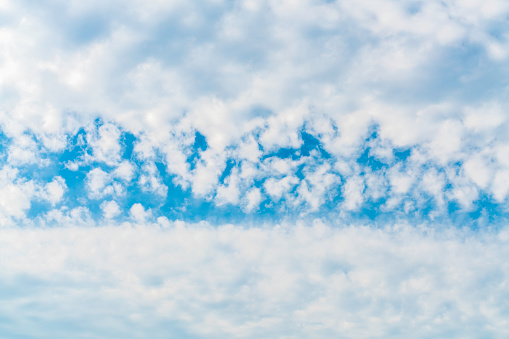 White clouds and bright sky background.