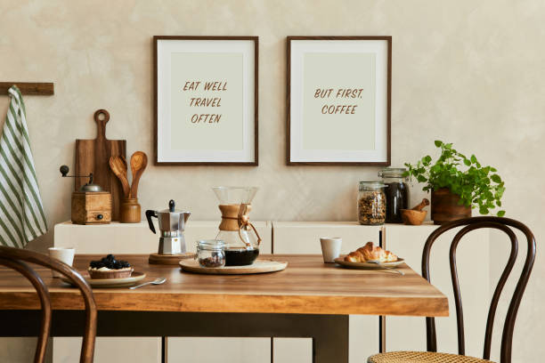 istock Elegant composition of stylish dining room interior with mock up poster frames, beige sideboard, family dining table, plants and vintage personal accessories. Copy space. Template. Autumn vibes. 1351054367