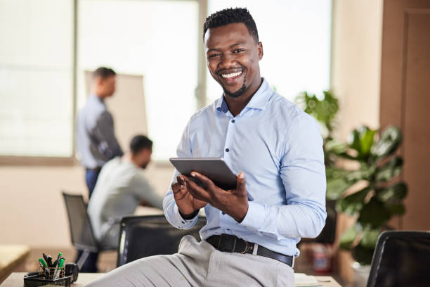 istock Shot of a young businessman using his digital tablet at work 1351059238