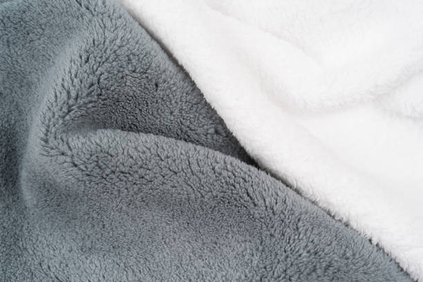 istock Fleece. Close-up warm, softness grey plaid on the bed, top view. Crumpled soft blanket 1351060227