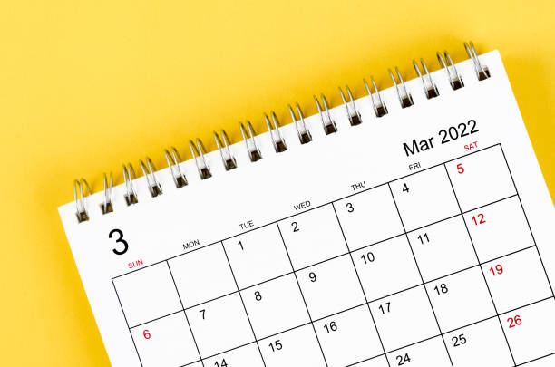 istock march 2022 desk calendar on yellow background. 1351061099