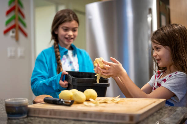 Siblings composting food scraps. Living a sustainable lifestyle.