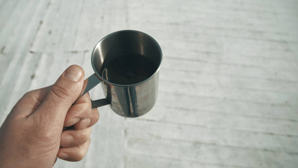 istock Close-up male hand with metal mug 1351063539
