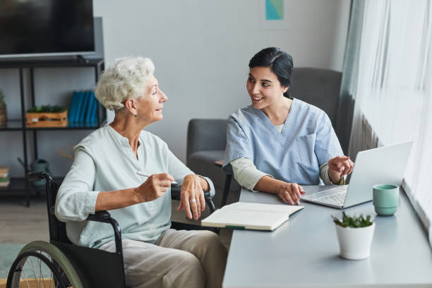 istock Young Nurse Assisting Senior Woman 1351063552