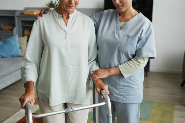 istock Senior Woman using Walker at Retirement Home 1351063588