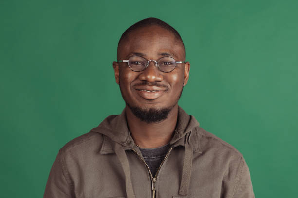 istock Close-up portrait of young african man posing isolated on studio background with copyspace for ad. 1351064661