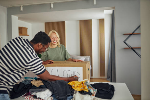 istock Lovely diverse couple preparing donation box at home 1351064760