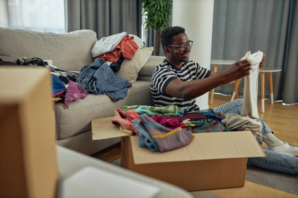 istock Black man organizing laundry for donation 1351065388