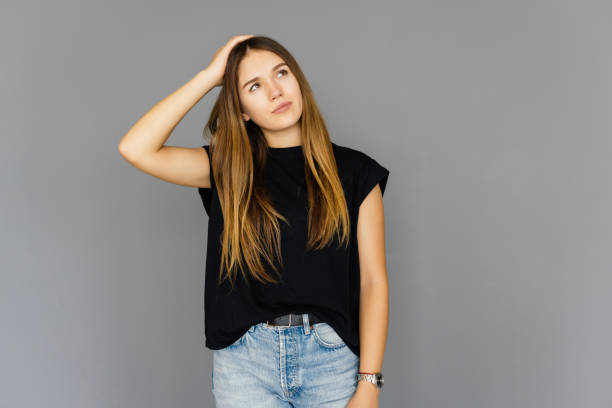 istock Young woman remembered importrant task she forgot, punching herself in forehead, dropping jaw and standing anxious over gray background, gesturing, being forgetful and intense, recalling something 1351065572