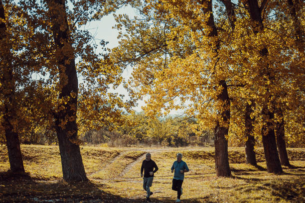 istock Senior friends jogging in nature 1351065631