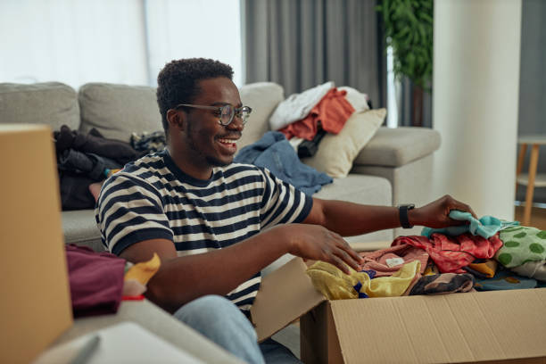 istock Man pack clothes and prepare for donation at home 1351065664