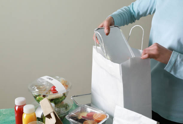 istock Worker of food delivery service packing order for customer 1351065734