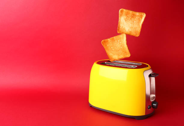 istock Toaster with bread slices on color background 1351065778
