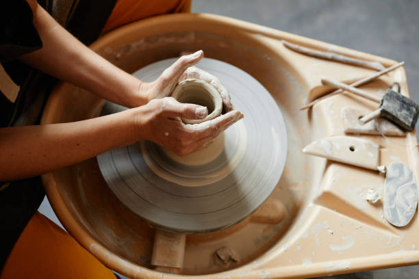 istock Female Hands Shaping Ceramics on Pottery Wheel 1351067036