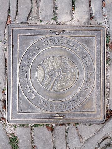 Groznjan, Istria, Croatia - October 30, 2021: A manhole cover on a cobblestone street in Groznjan