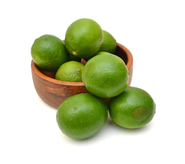 istock A green lemons on wooden bowl 1351068594