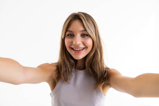 istock Young beautiful woman taking selfie. Isolated white background 1351070405