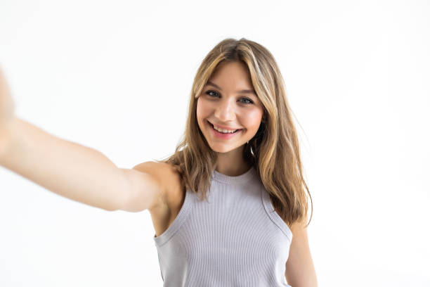 istock Young beautiful woman taking selfie. Isolated white background 1351071339