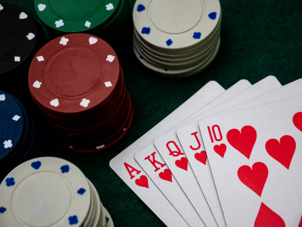 istock Royal straight flush poker cards with stack of poker chips 1351071510