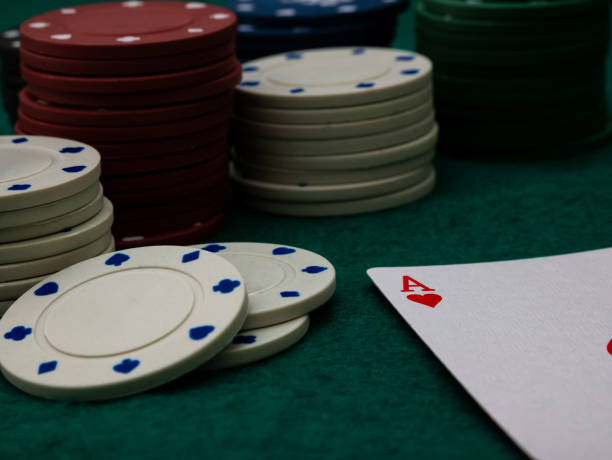 istock poker game table, single ace card score with stack of playing chips 1351071513